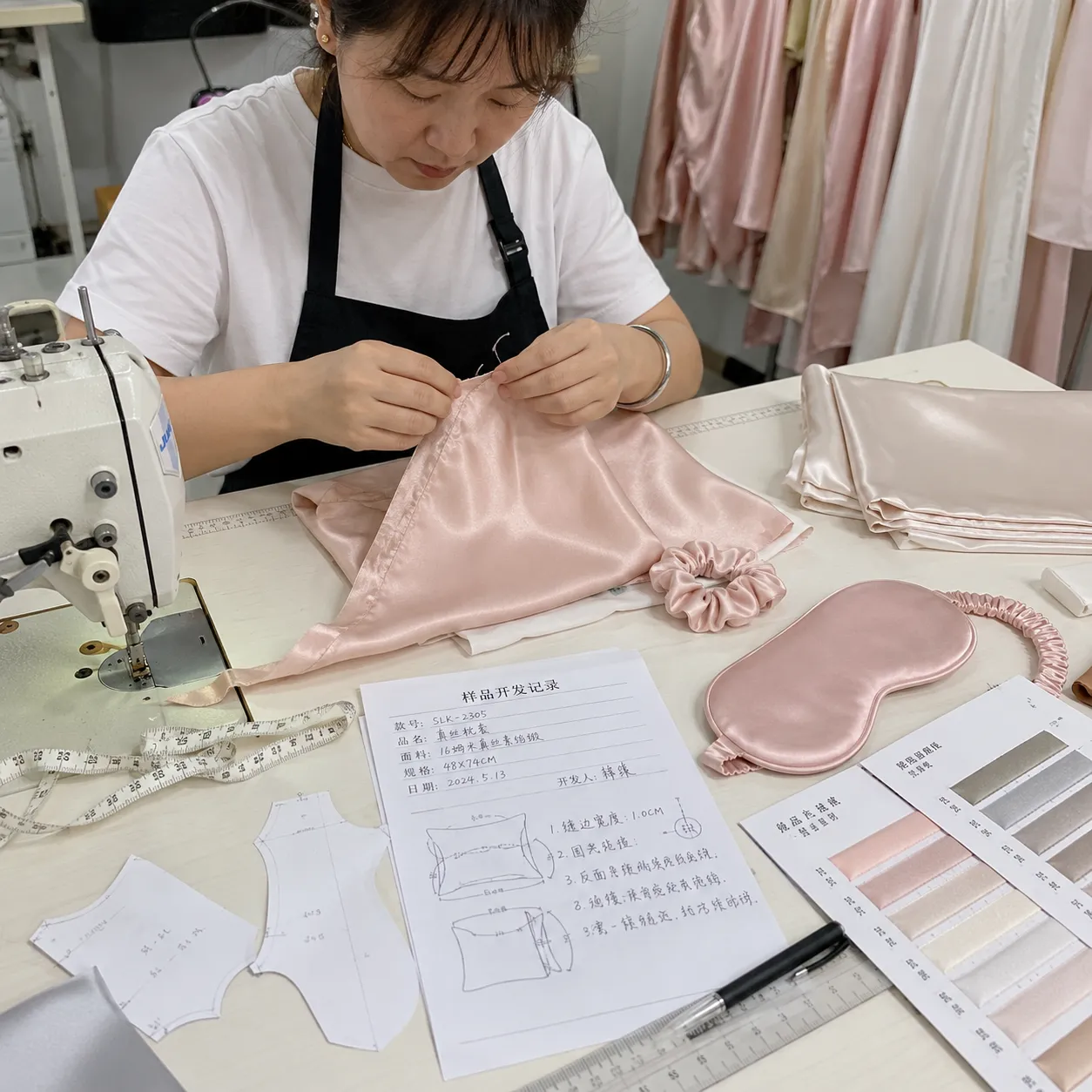 OlaSilk in-house silk product sampling and prototyping with pattern notes, color swatches, and hand finishing for B2B private label brands
