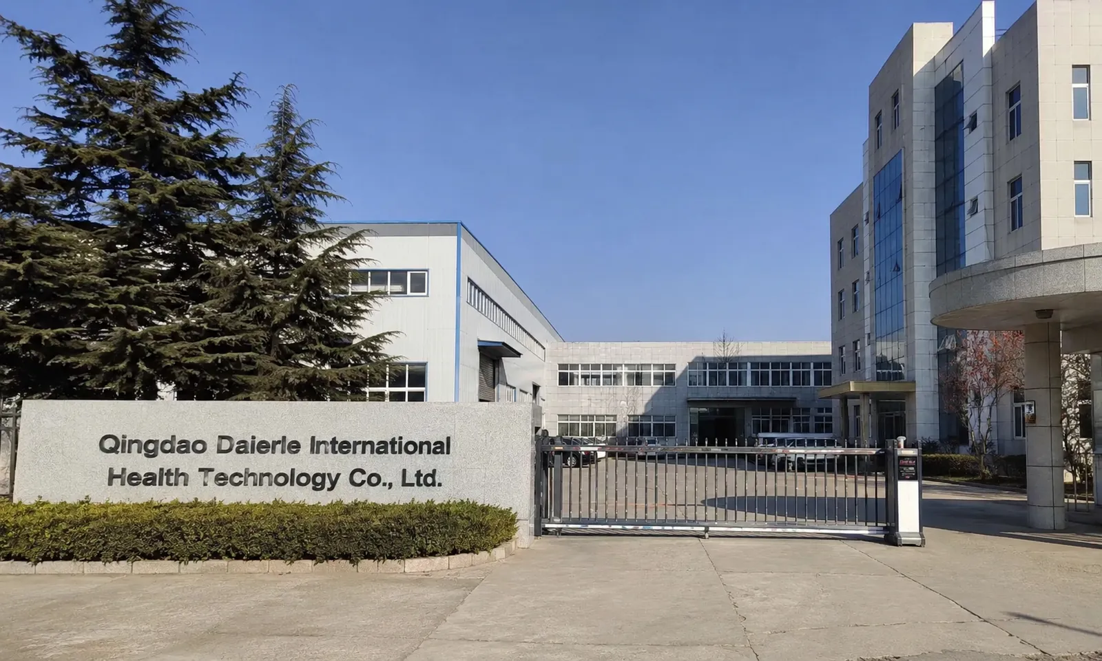 OlaSilk supplier facility exterior showing company buildings and gated entrance, reflecting in-house support for B2B private label silk brand projects
