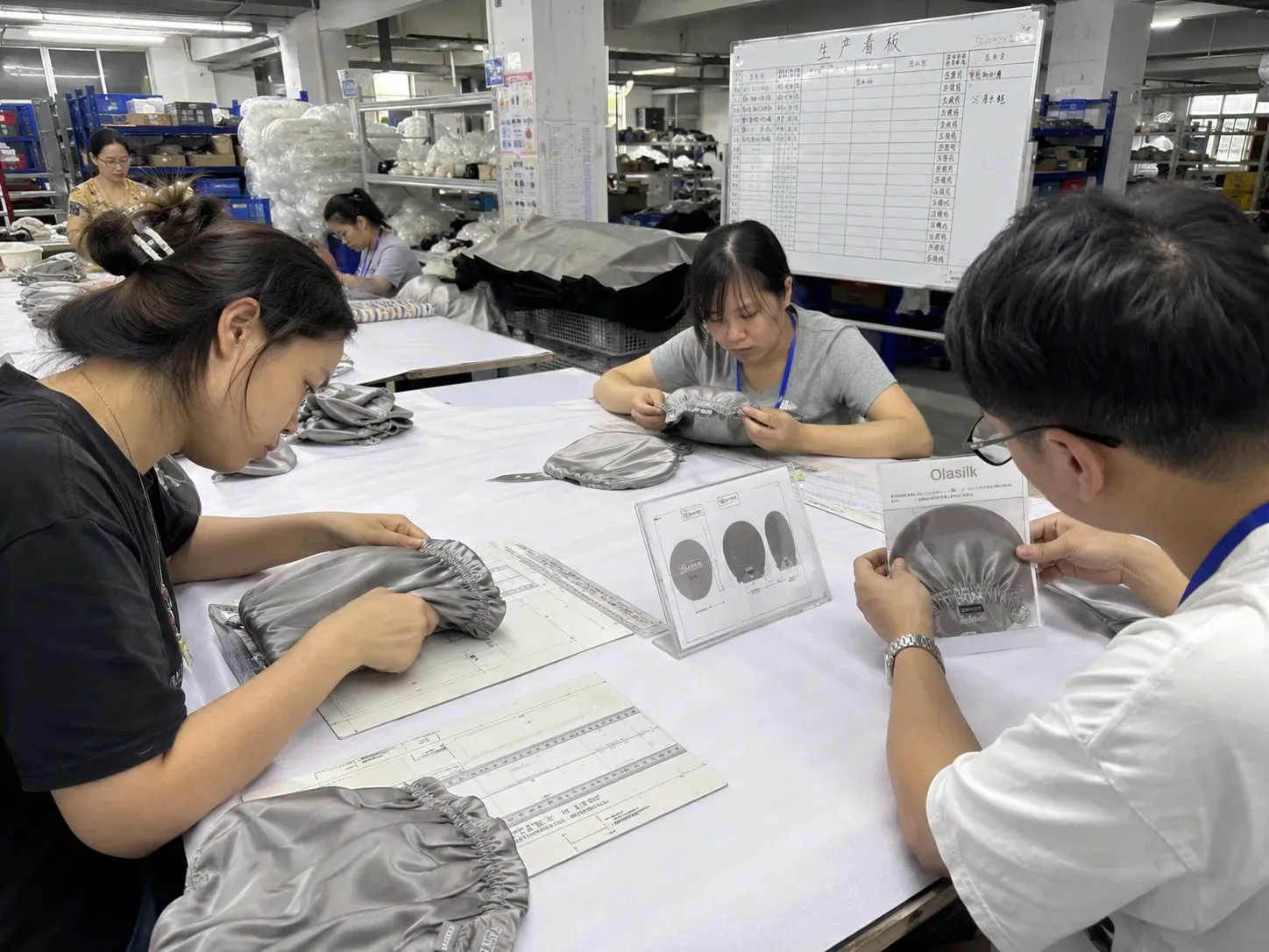 In-process quality check during sewing at OlaSilk private label silk manufacturing, ensuring consistent quality for B2B orders.