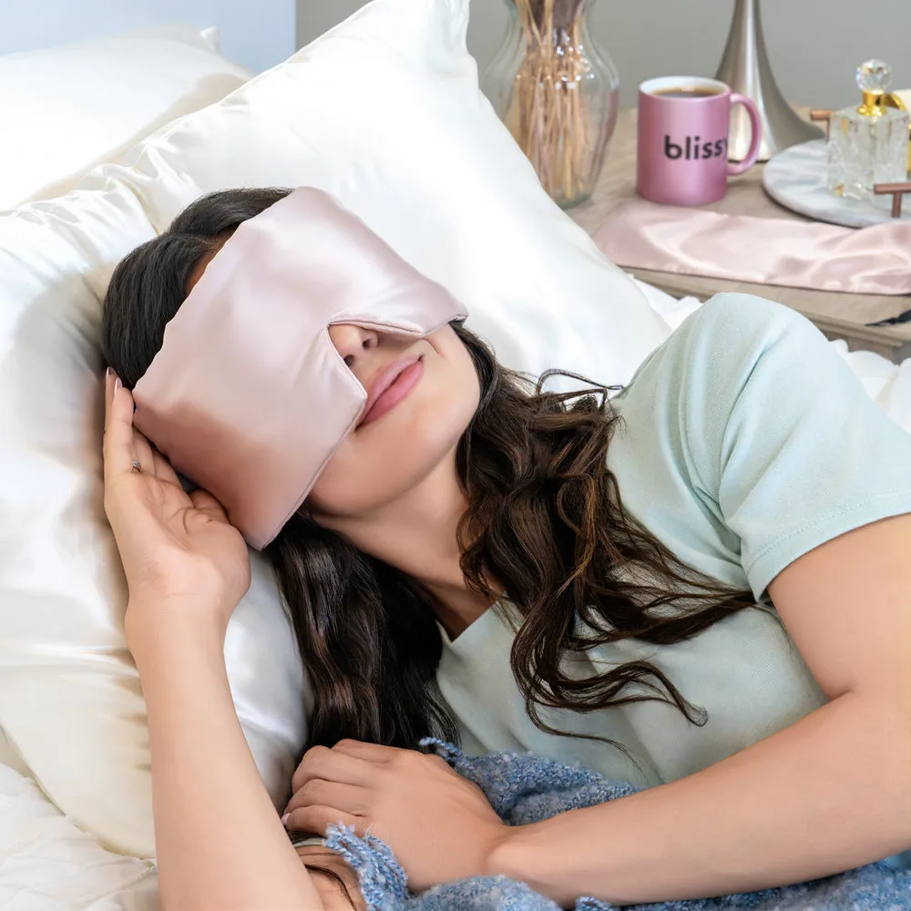 Lifestyle image of blush private label silk sleep mask for spa, beauty, and travel gift set programs