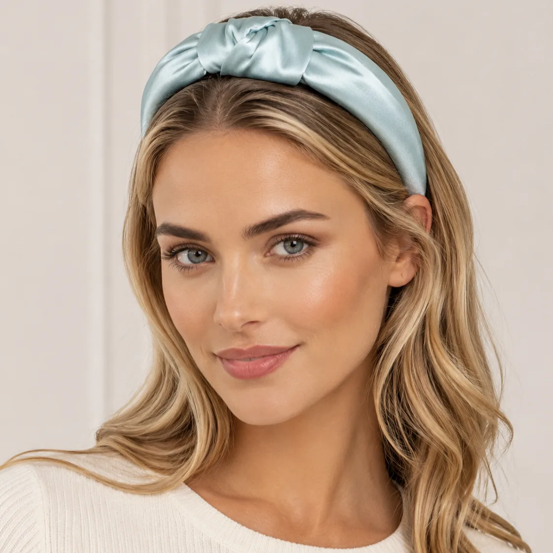 Pale blue knotted custom silk headband styled on model for private label beauty, hair care, and gift set programs
