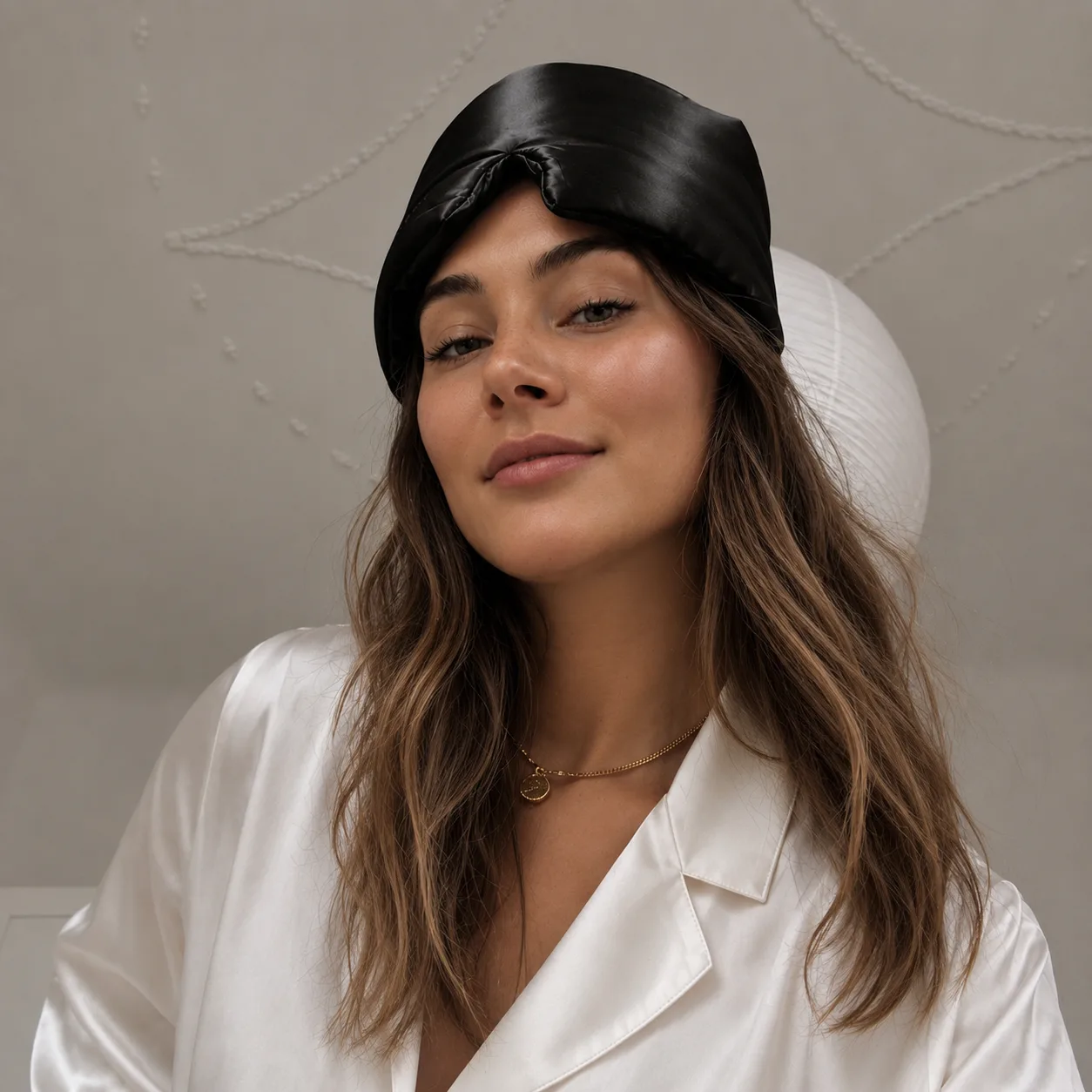 Lifestyle image of black 3D molded silk sleep mask for private label beauty, travel, spa, and gift brand programs