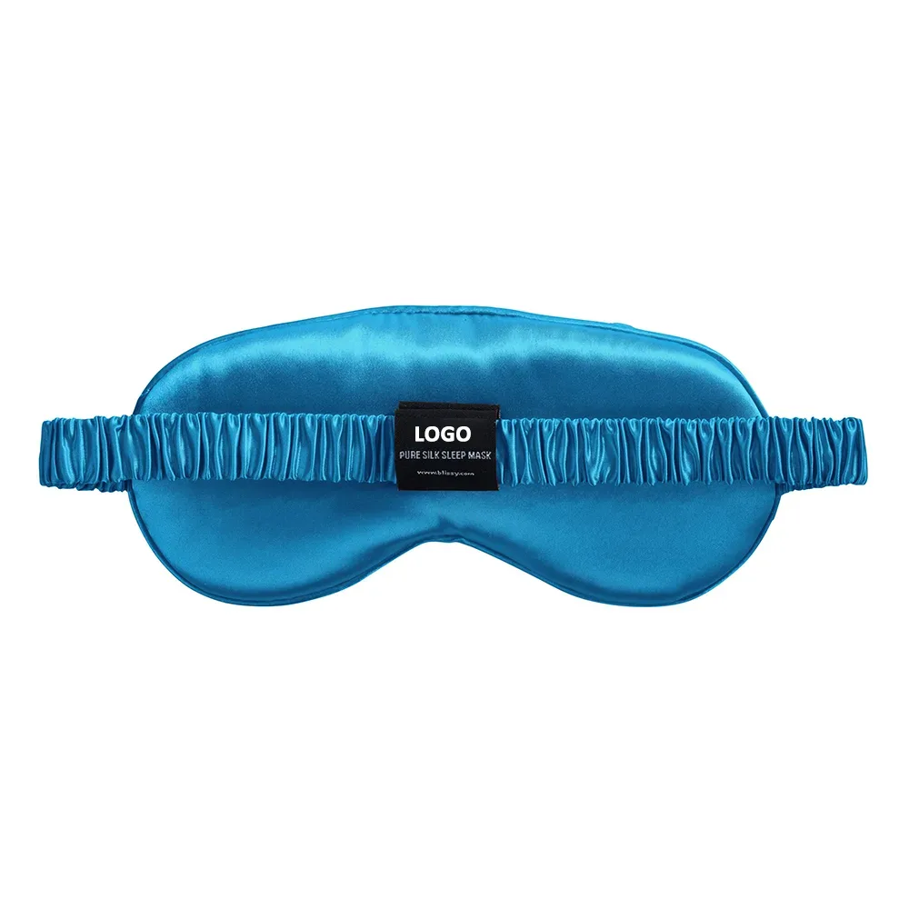 Back view of blue classic silk sleep mask with elastic strap and custom logo label for private label sleepwear brands