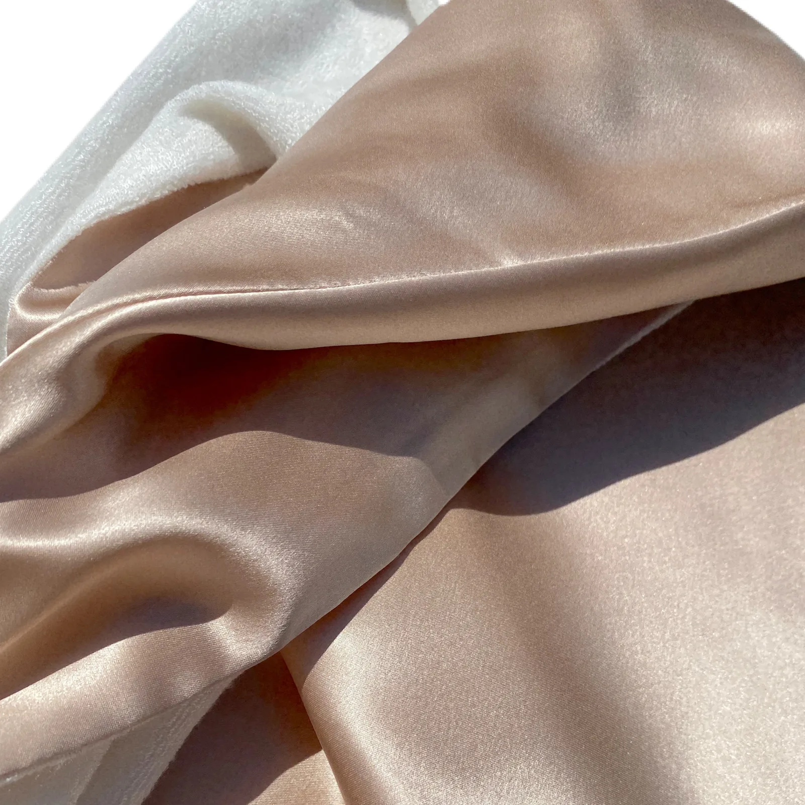 Detail view of custom silk hair towel wrap with smooth champagne outer fabric and soft white lining for private label hair care sets
