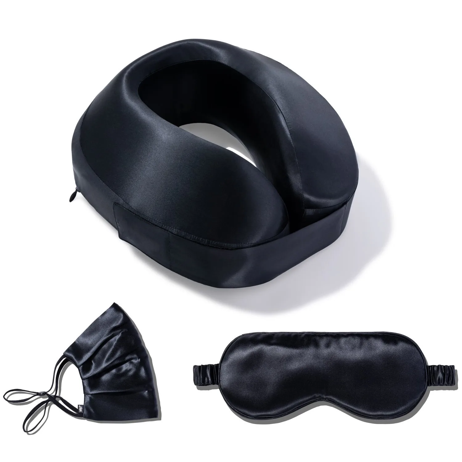 Black silk 3-piece travel sleep set with neck pillow, eye mask, and face mask displayed with private label packaging tote