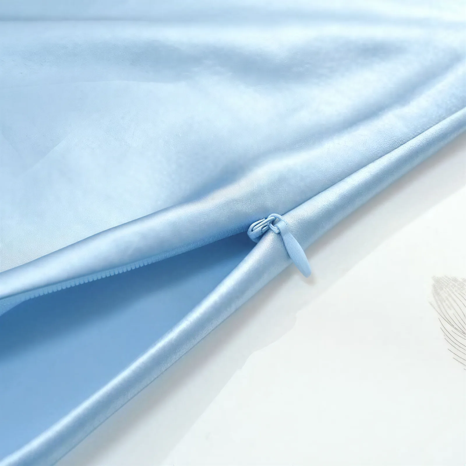 Light blue custom silk pillowcase close-up showing hidden zipper detail for private label hair and sleep care brands