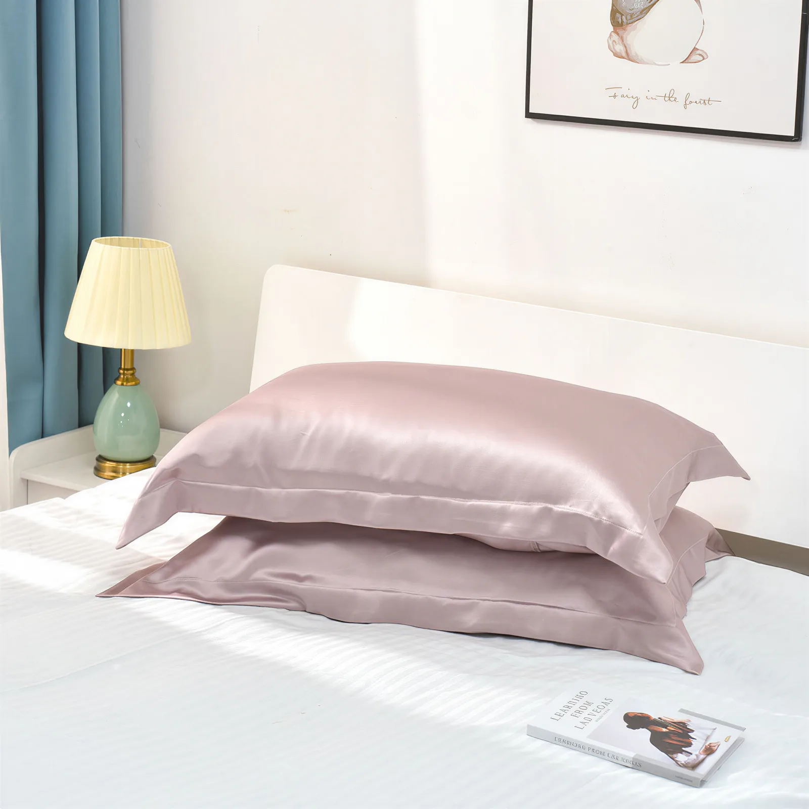 Blush pink custom silk pillowcase set styled in a bedroom for private label hair and sleep care brands