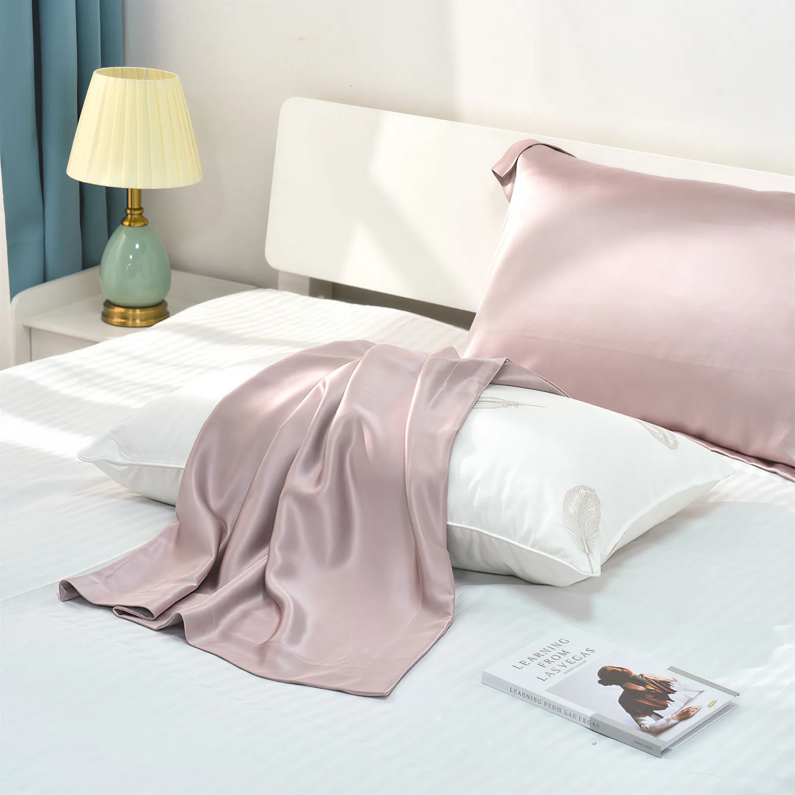 Blush pink custom silk pillowcase in bedroom lifestyle display for private label hair and sleep care lines