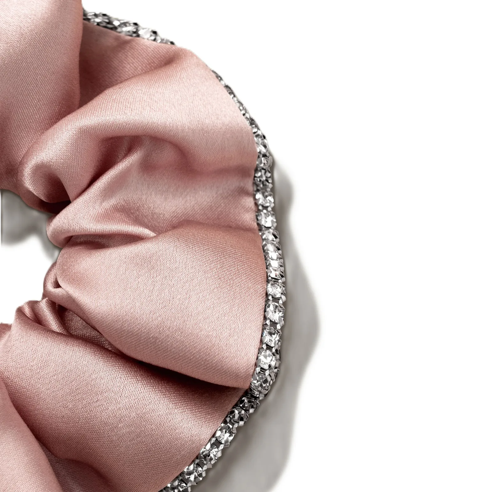 Close-up of dusty pink custom silk scrunchie with rhinestone trim for private label hair accessory and gift set programs