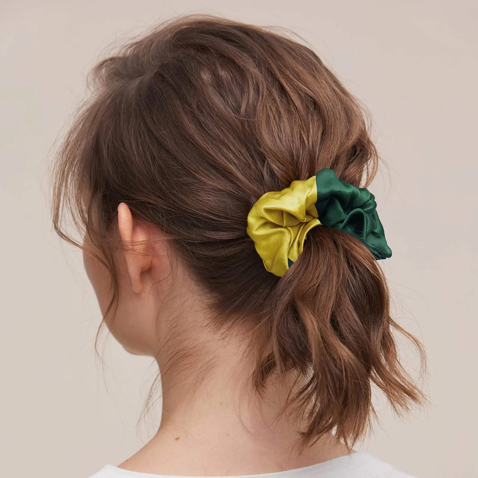 Colorblock custom silk scrunchie in green and yellow shown in ponytail for private label hair accessory and gift set brands