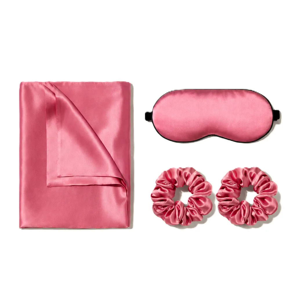Coral pink silk sleep gift set with pillowcase, sleep mask, and two scrunchies for private label beauty brand programs