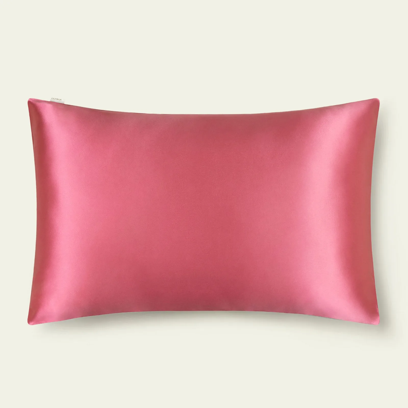 Pink silk pillowcase detail view with smooth finish and small edge label for private label bedding programs