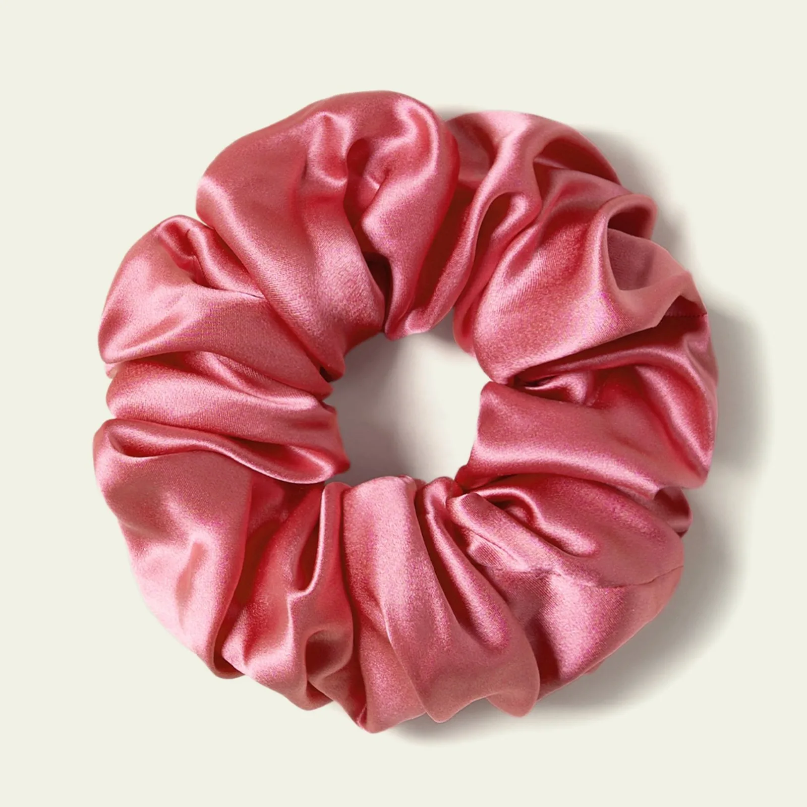Pink glossy fabric scrunchie detail view for private label hair care, beauty retail, and gift set customization
