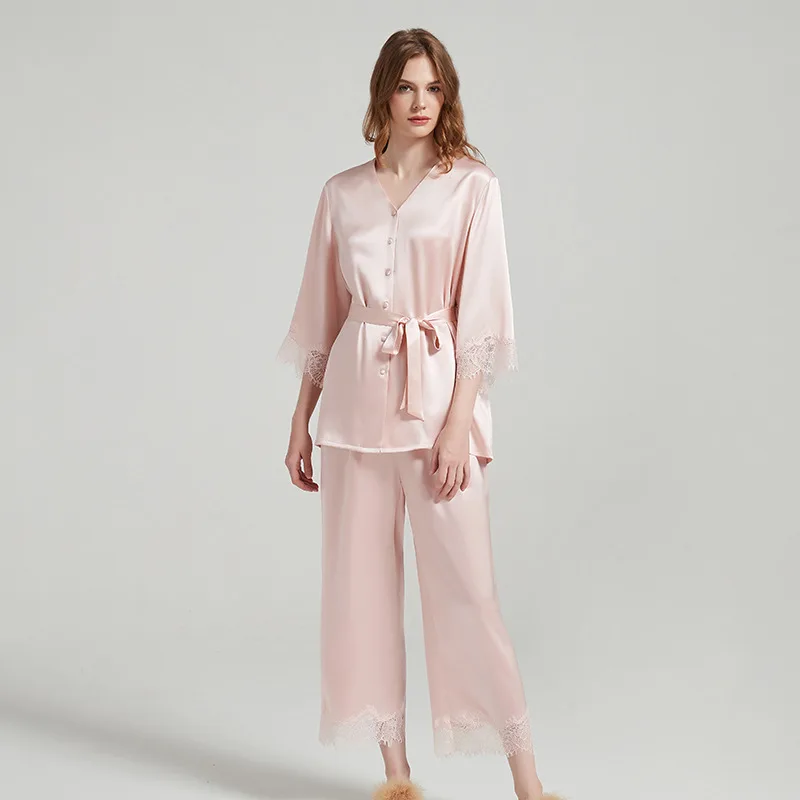 Blush pink custom silk pajama set with belted button top and lace-trim cropped pants for private label sleepwear brands