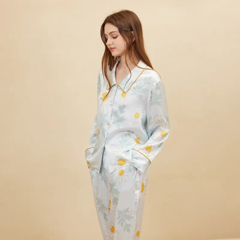 Detail view of custom silk pajama set with floral print, button-front shirt, and contrast piping for private label sleepwear branding