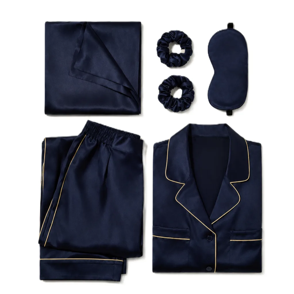 Six-piece navy silk pajama sleep set with gold piping, pillowcase, eye mask, and scrunchies for private label brand programs