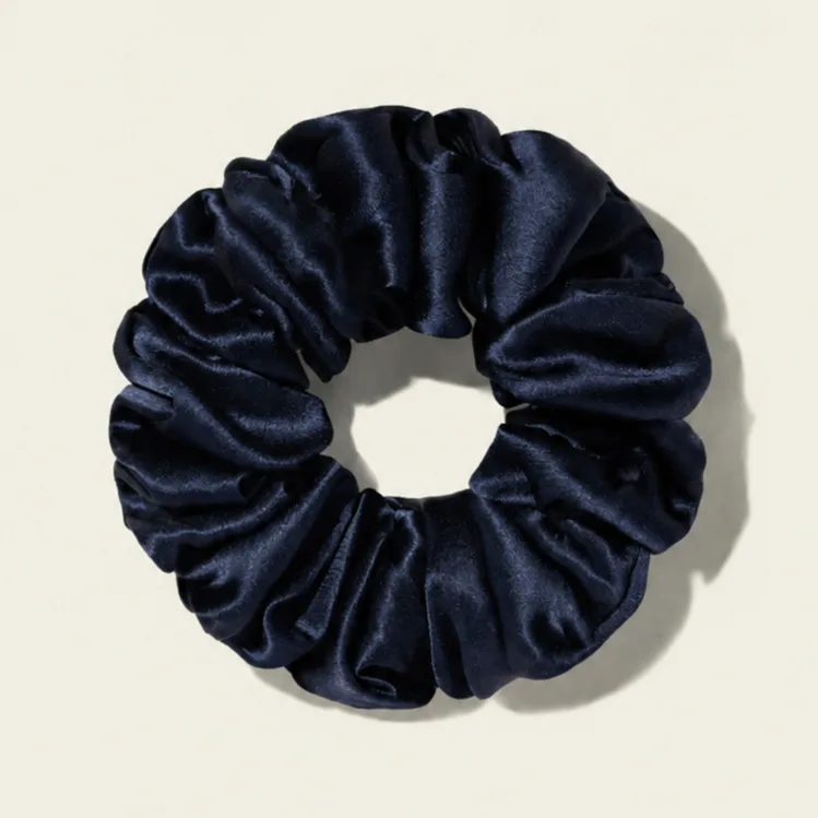 Detail view of glossy navy scrunchie for custom beauty, spa, and retail gift set private label programs