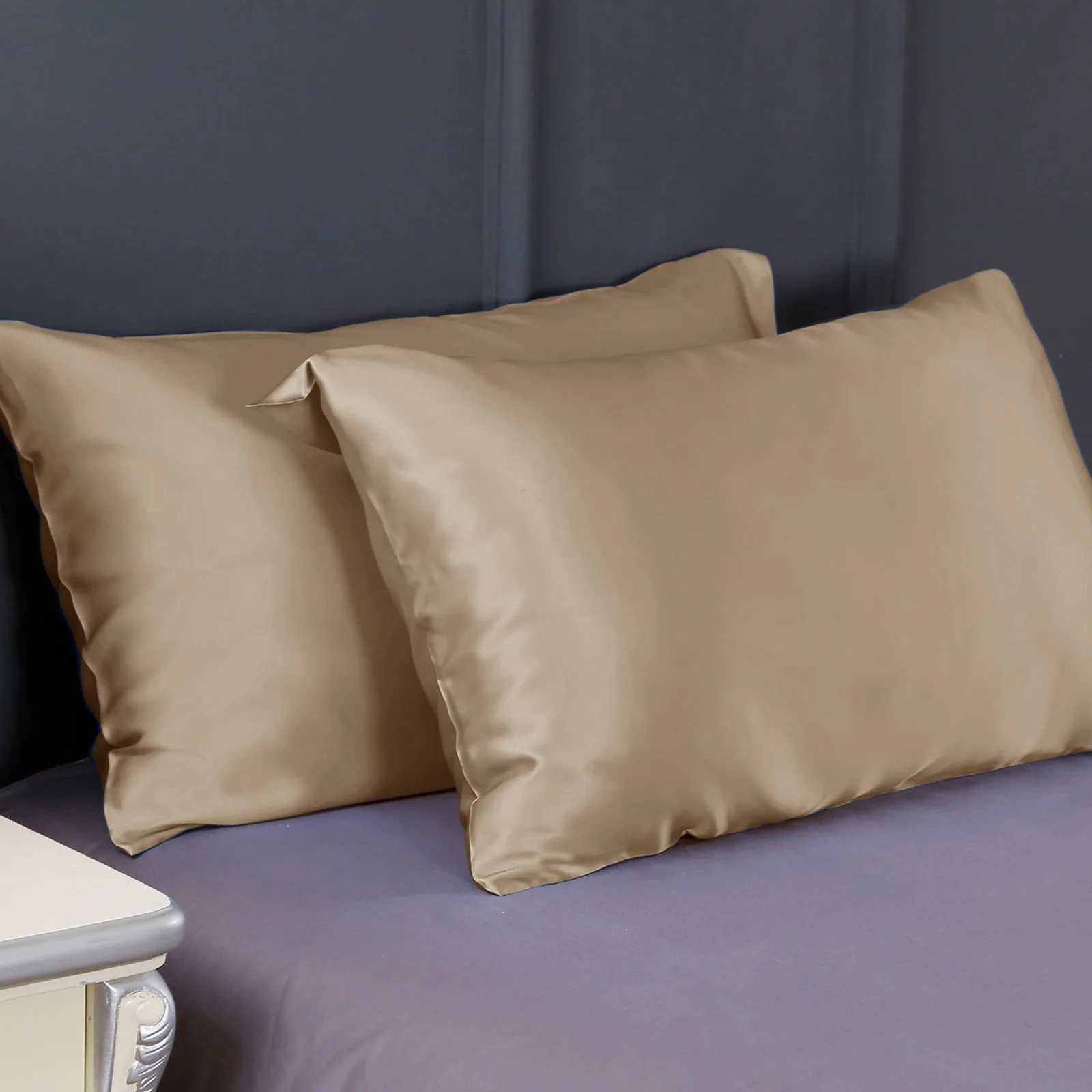 Lifestyle detail of champagne-toned smooth pillowcases as a private label silk care gift set component