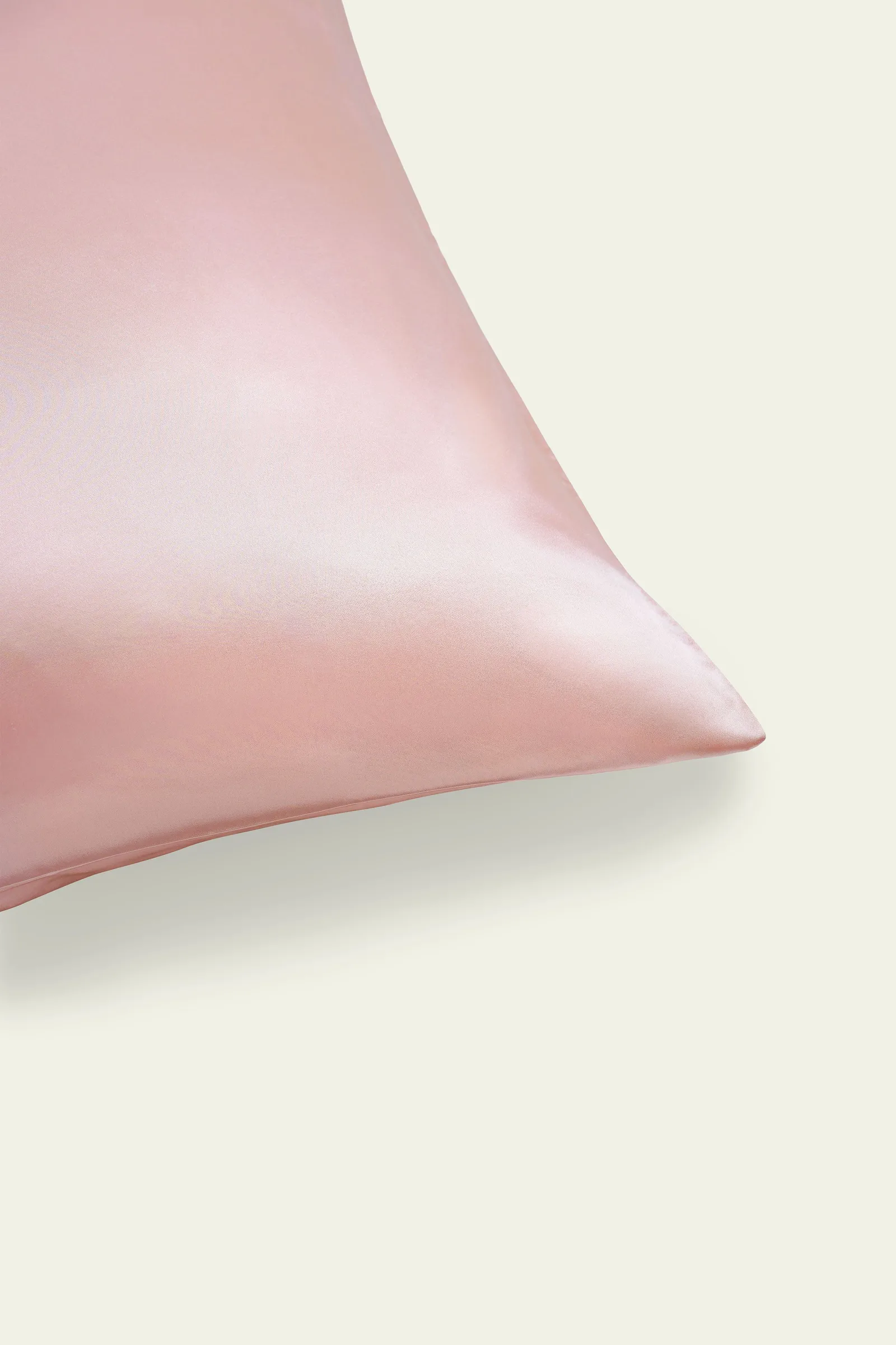 Detail view of blush pink pillowcase corner with smooth sheen and seam finish for private label silk gift set sample review