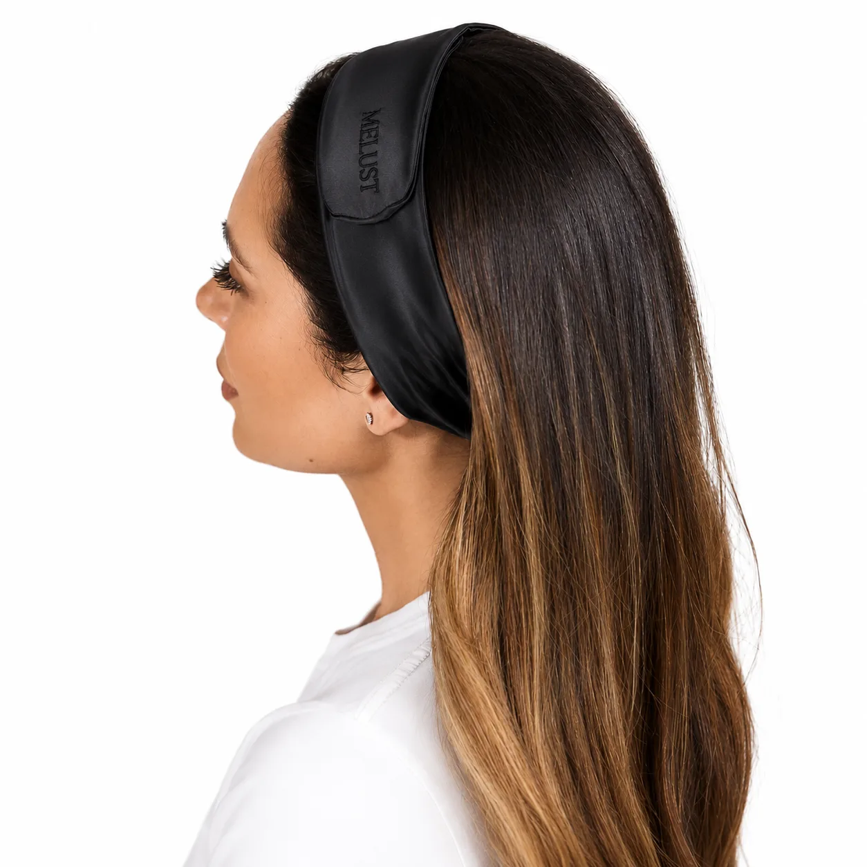 Black wide custom silk headband with tonal logo placement shown on model for beauty brand private label review