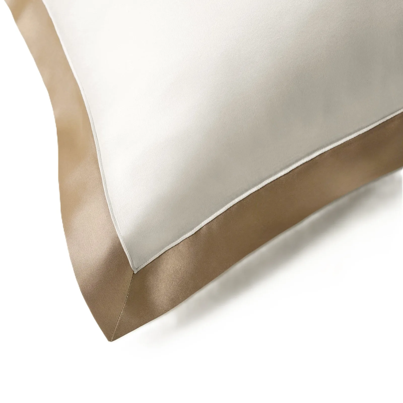 Detail view of custom silk pillowcase with ivory center, champagne border, and piped edge for private label hair and sleep care lines