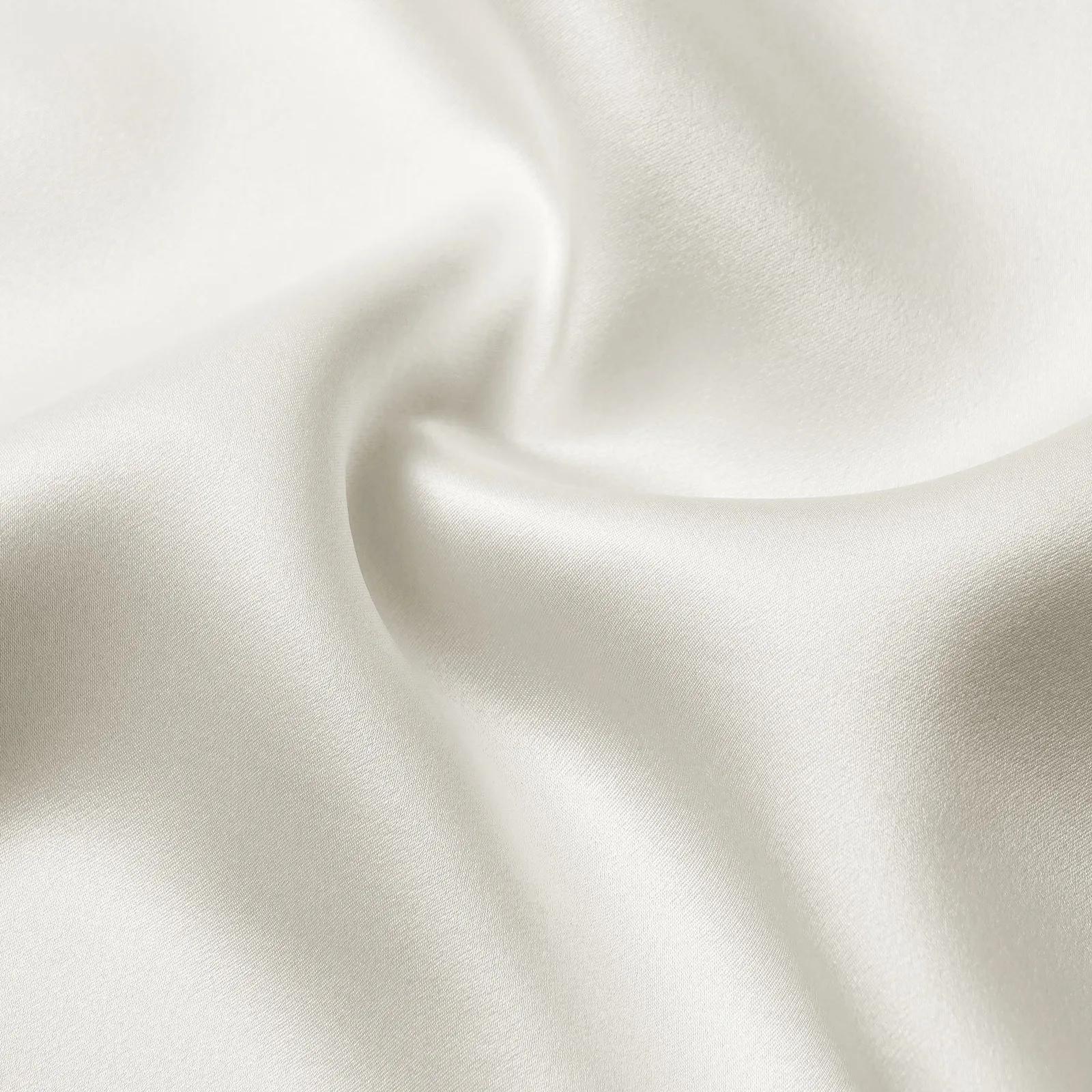 Close-up ivory custom silk pillowcase fabric texture for private label hair and sleep care lines