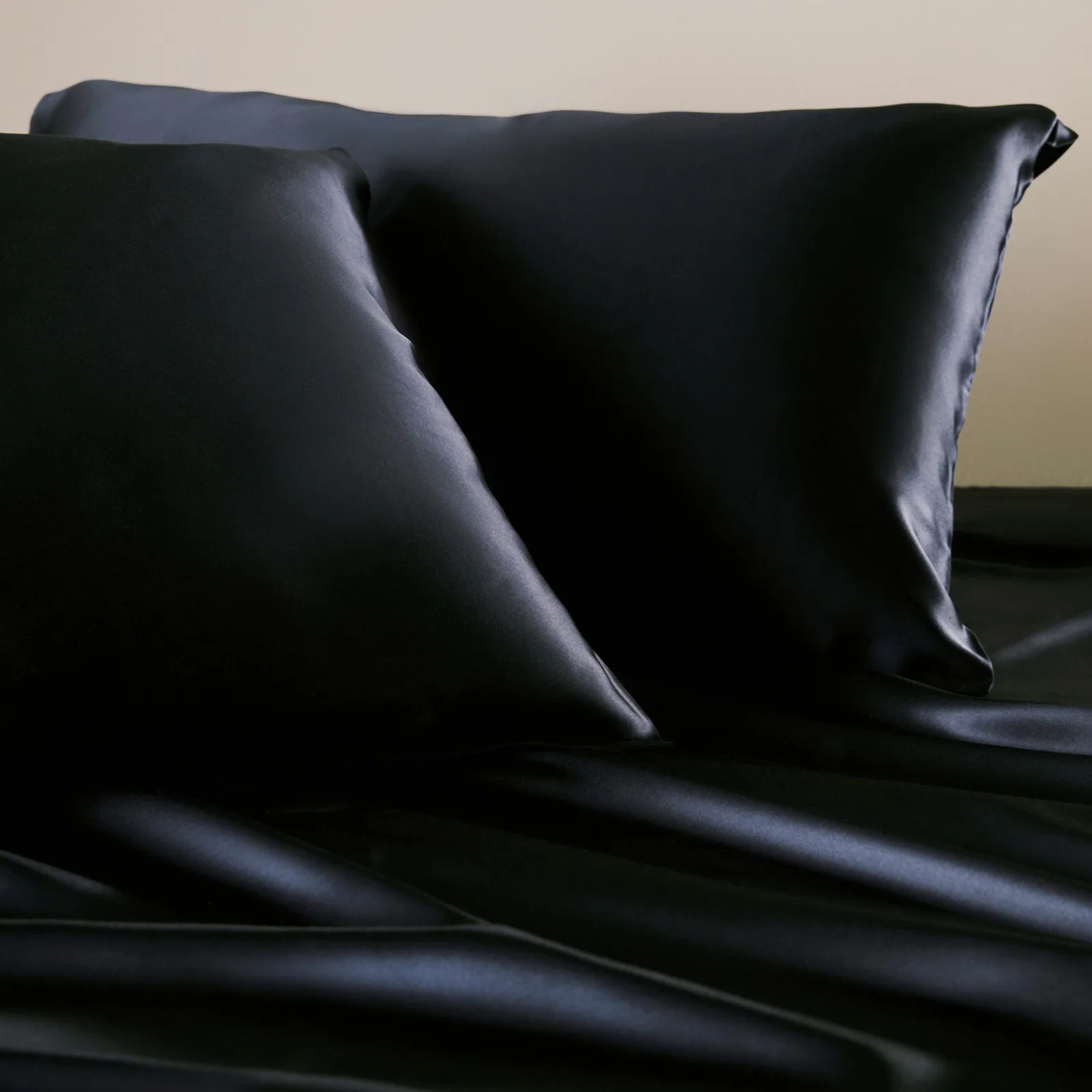 Black custom silk bedding set with pillowcases and sheets for private label hotel, spa, and retail programs