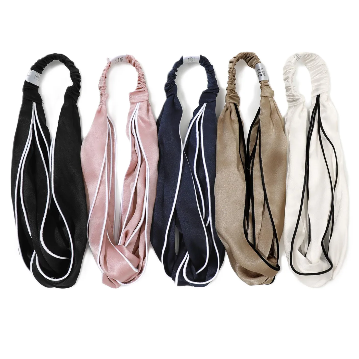 Color variant lineup of custom silk headbands with contrast piping for private label beauty and hair accessory brands
