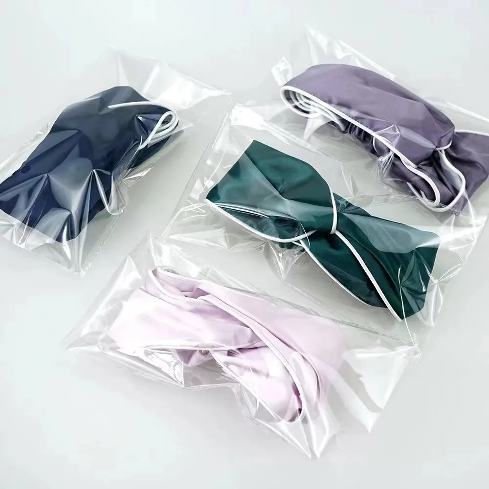 Individually packaged custom silk headbands in assorted brand colors for private label beauty and hair accessory collections