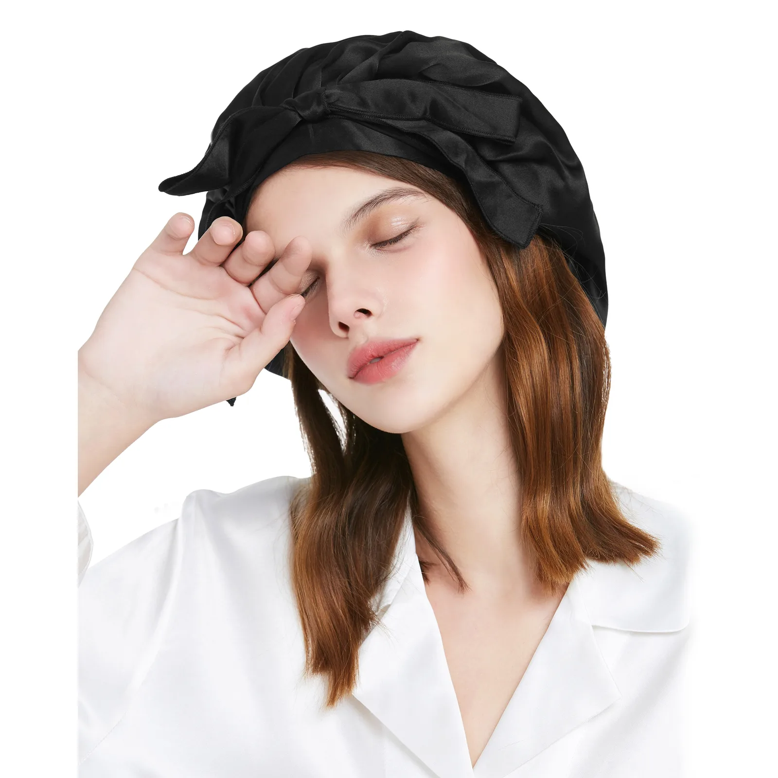 Model wearing black custom silk sleep cap with bow detail for private label hair care and beauty brand programs