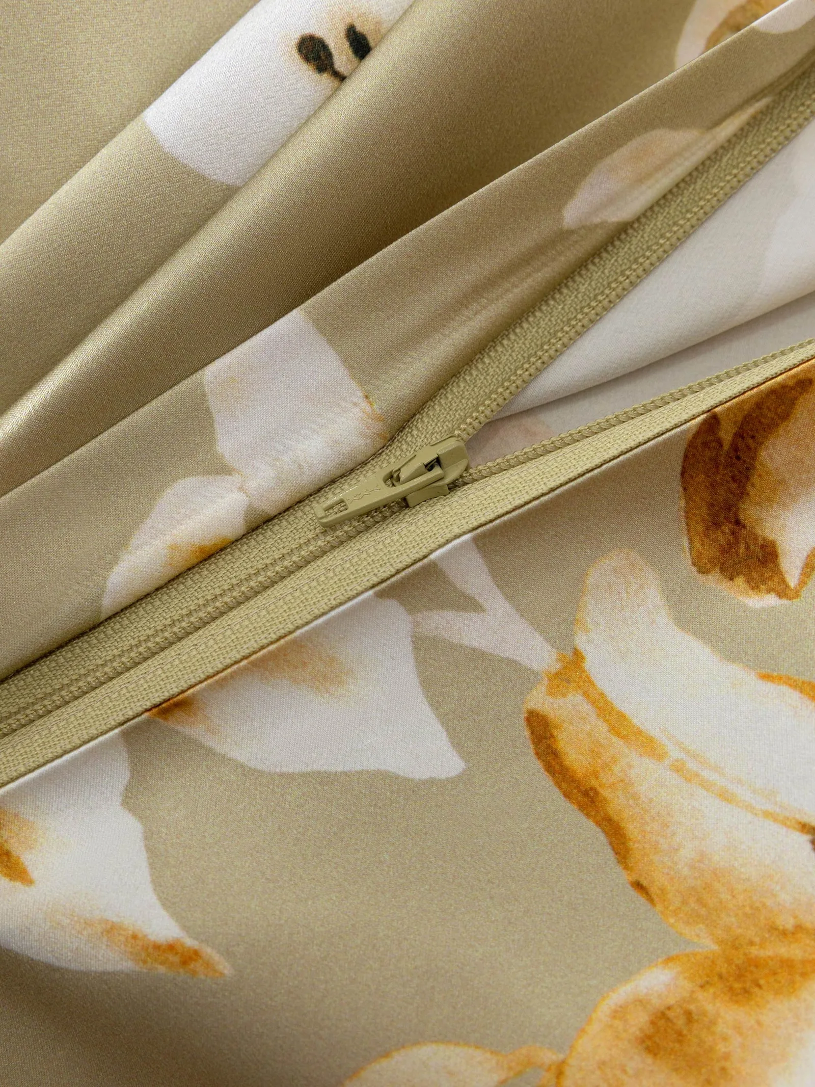 Custom silk bedding detail showing tonal zipper and floral print for private label duvet cover sample review