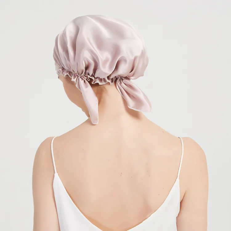 Back detail of custom silk sleep cap with gathered edge and tie bow for private label hair care brands