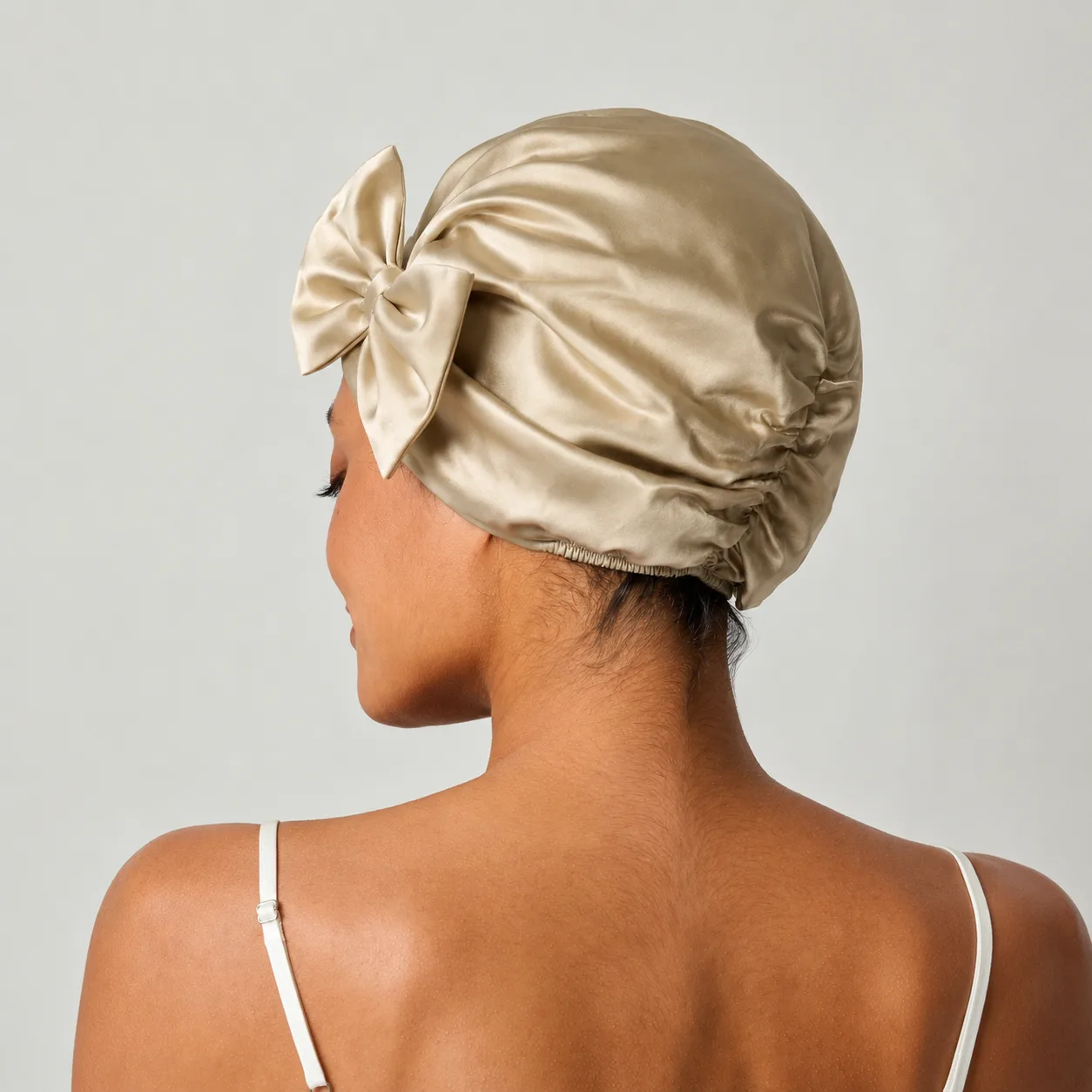 Custom silk sleep cap style with champagne bow and gathered elastic back for private label hair care brands