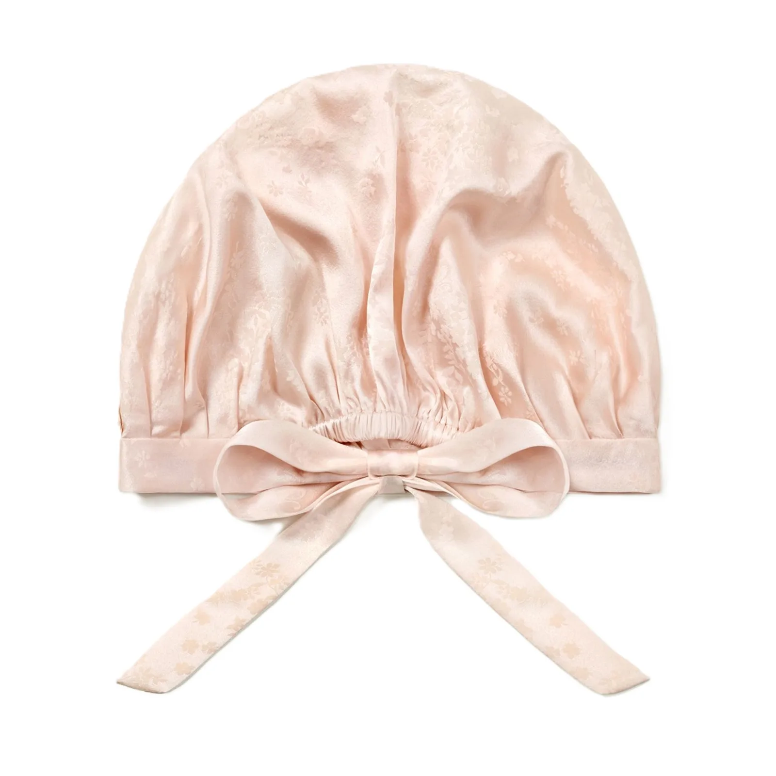 Back detail of blush custom silk sleep cap with elastic gathering and bow tie for private label hair care brands