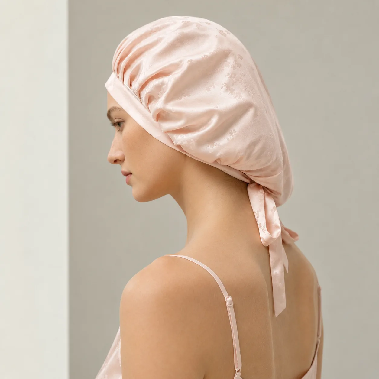 Pink floral jacquard custom silk sleep cap with tie-back fit for private label hair care and beauty brands