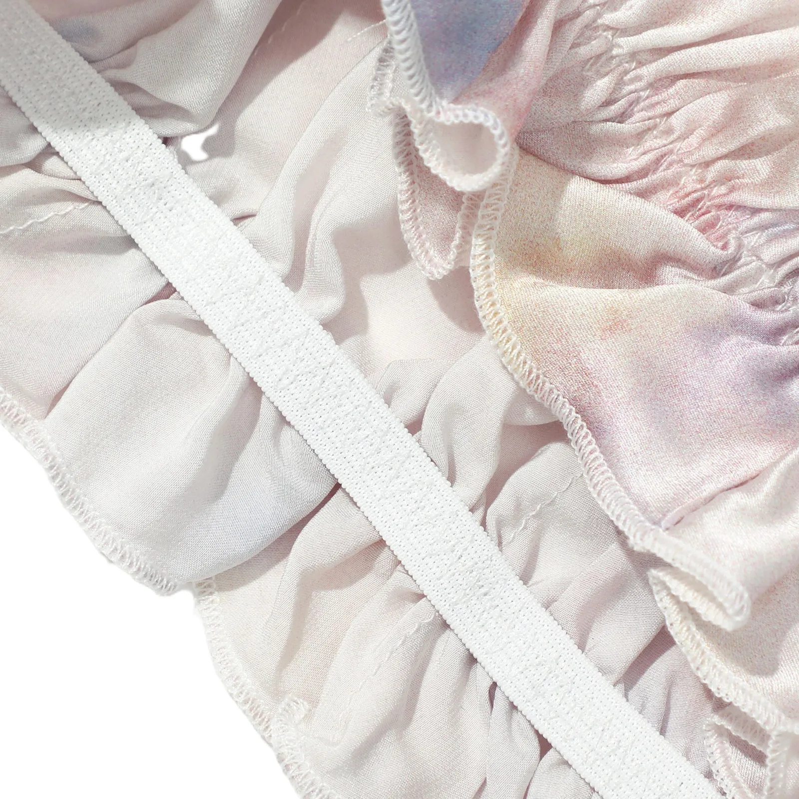 Detail view of custom silk sleep cap with elastic band and soft gathered edge for private label hair care brands