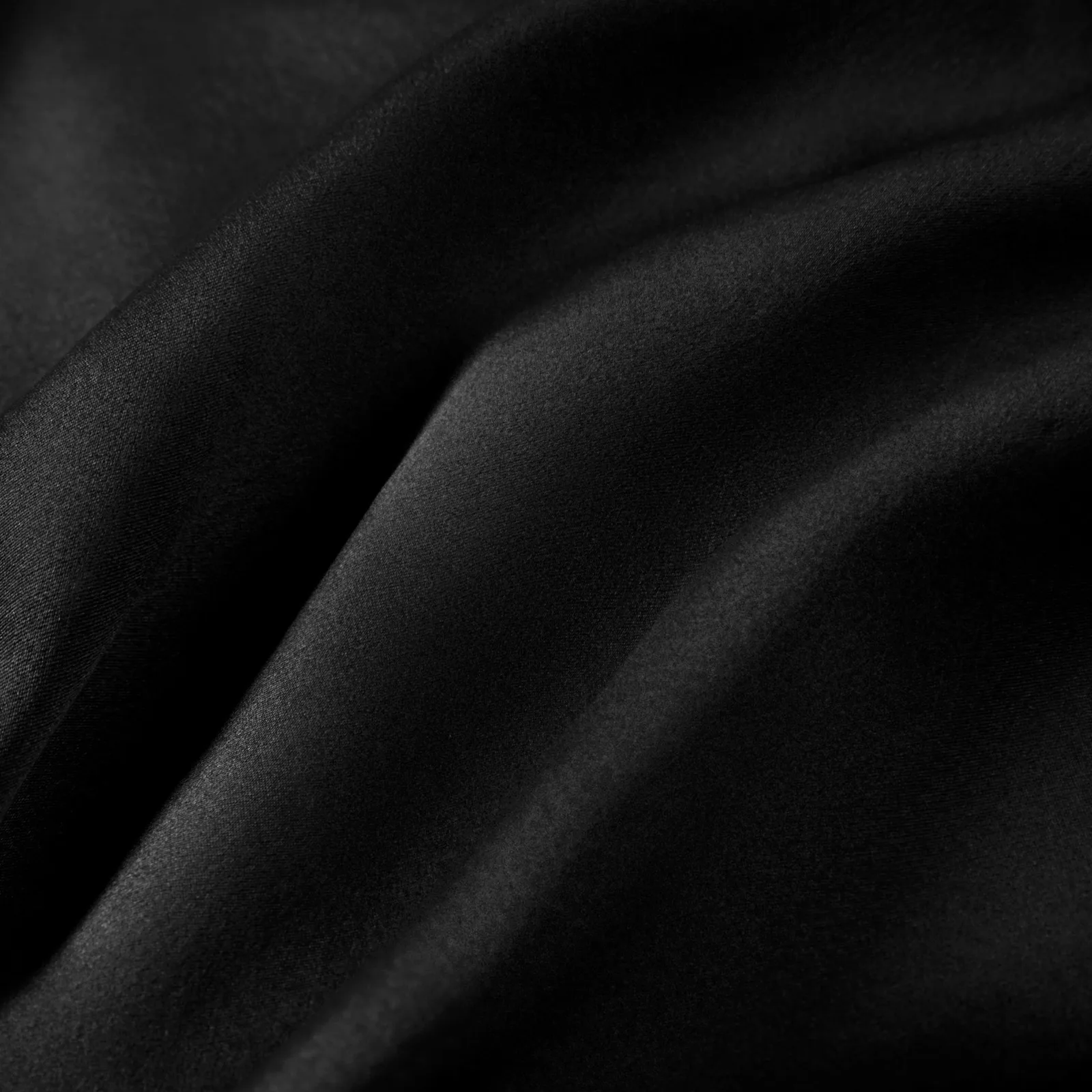 Black fabric detail for custom silk sleep caps, showing texture and color review for private label hair care brands