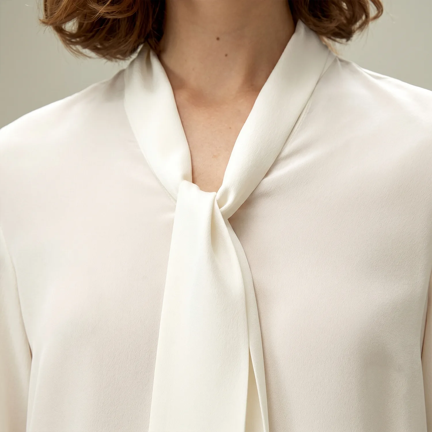 Ivory tie-neck blouse detail for custom silk clothing private label apparel brands