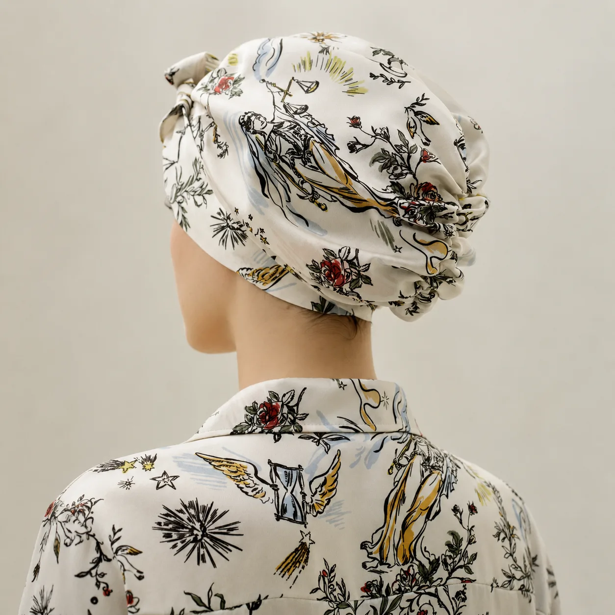 Detail view of custom printed silk sleep cap with gathered back, shown with matching robe for private label hair care and beauty brands