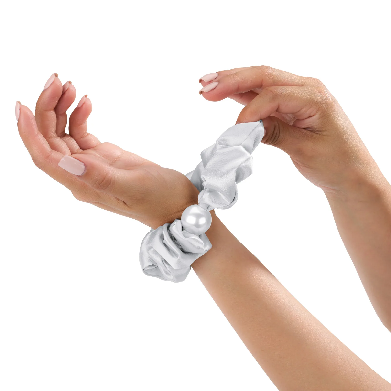 Detail view of pearl accent silk scrunchie worn on wrist for private label hair accessory customization
