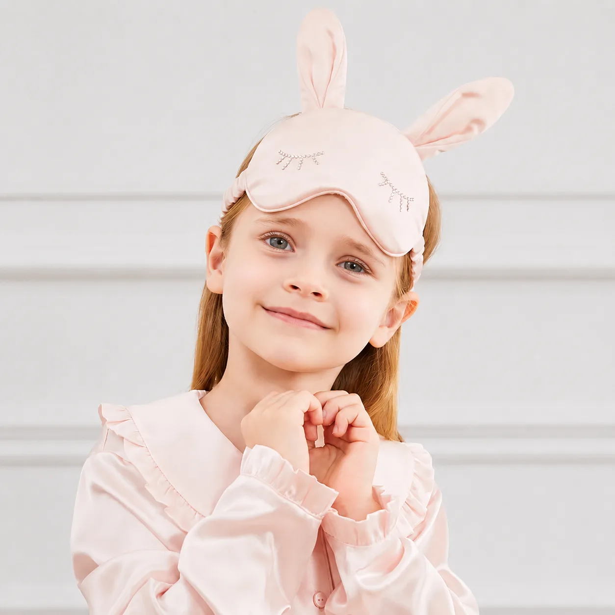 Kids silk sleep mask with padded bunny-ear shape, piped edge, contoured eye cover, and elastic head band for private label fit review