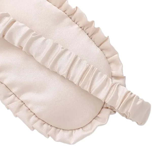 Custom kids silk sleep mask detail showing padded rounded eye panel, gathered ruffle edge, sewn seams, and elastic strap for secure comfort fit