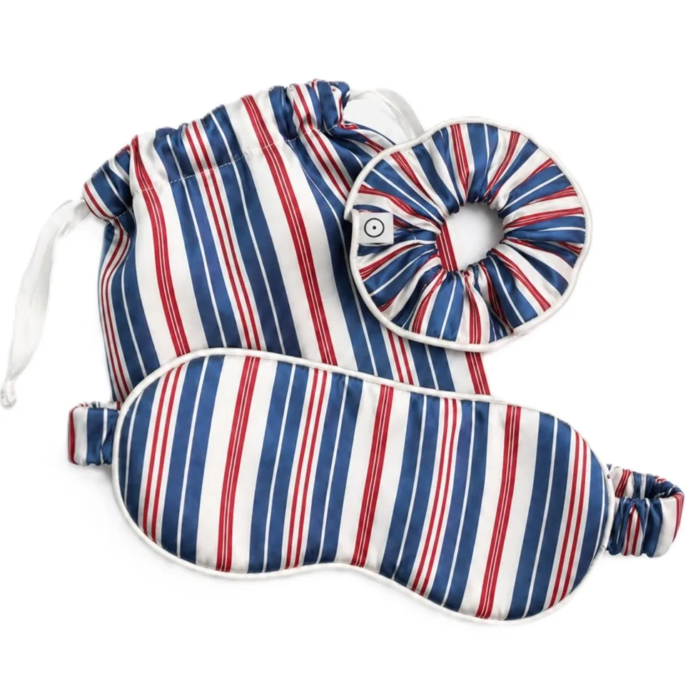 Three-piece private label silk sleep travel set in navy red white stripe print including padded eye mask scrunchie and drawstring pouch