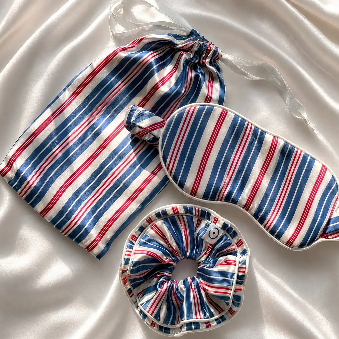 Private label sleep mask and scrunchie set showing padded mask structure, piped edge finish, rounded seams, and gathered elastic fit for