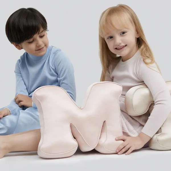 M-shaped custom kids silk cushion with rounded padded construction, piped edges and soft seams for comfortable private label use