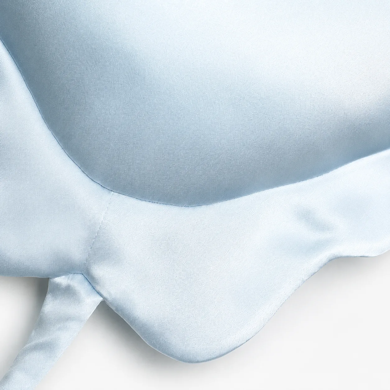 Detail view of star-shaped kids silk pillow showing rounded padded points and sewn edge seams for private label comfort review