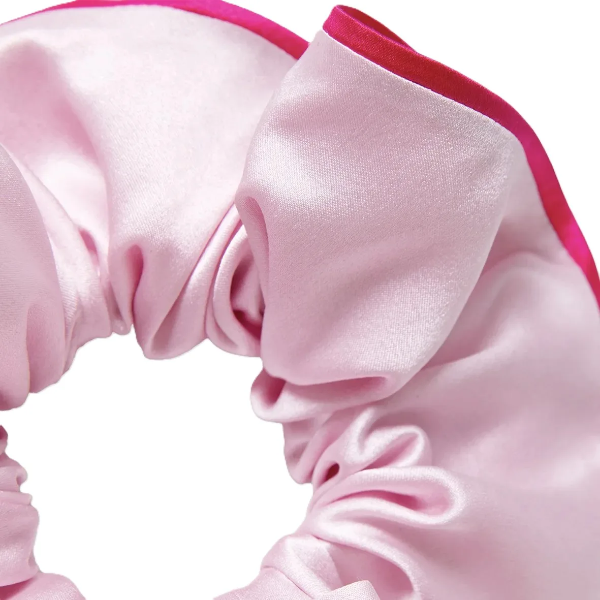 Detail view of custom silk scrunchie with gathered fabric tube, bound edge finish, and elastic core for comfortable private label hair accessory fit