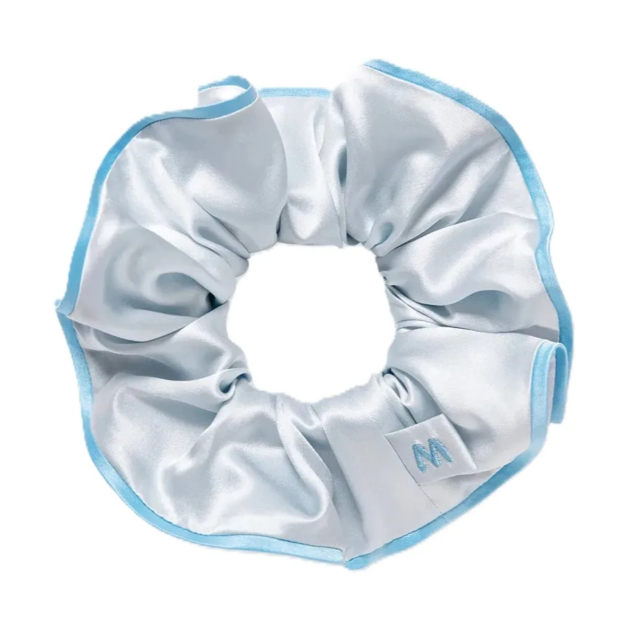 Circular silk scrunchie with gathered fabric, elastic band core and stitched edge binding for comfortable private label hair accessory use