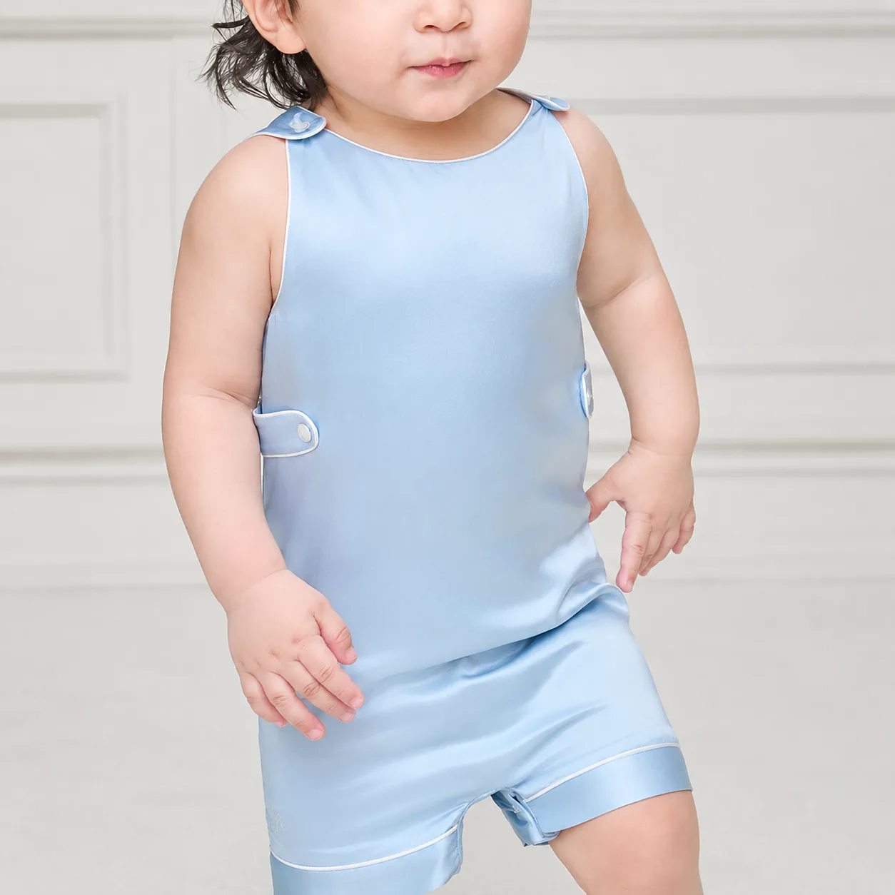 Kids silk loungewear set with sleeveless cut, piped edges, shoulder snap tabs, side closure tabs, and relaxed fit for private label comfort review