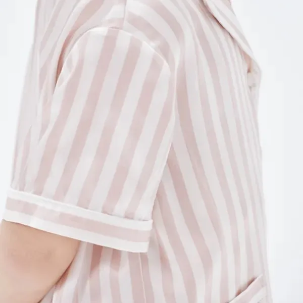 Detail of custom kids silk pajama top with short sleeve, folded cuff, shoulder seam and relaxed fit for private label sleepwear